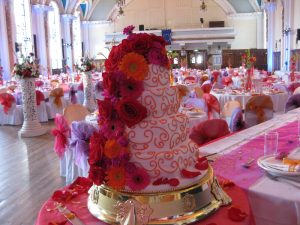 4 tiered wedding cake with pink and orange gerberas | Simplicity events | Asian Weddings