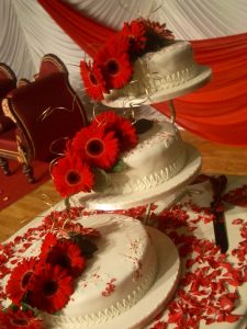 3 tiered wedding cake with red gerberas | Simplicity events | Asian Weddings