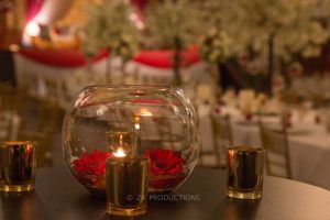 Gold candle holders and gerbera fish bowl centerpiece | Simplicity events | Asian Weddings
