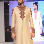 Asian Wedding Experience 2016 catwalk | Groom in gold with red detail sherwani